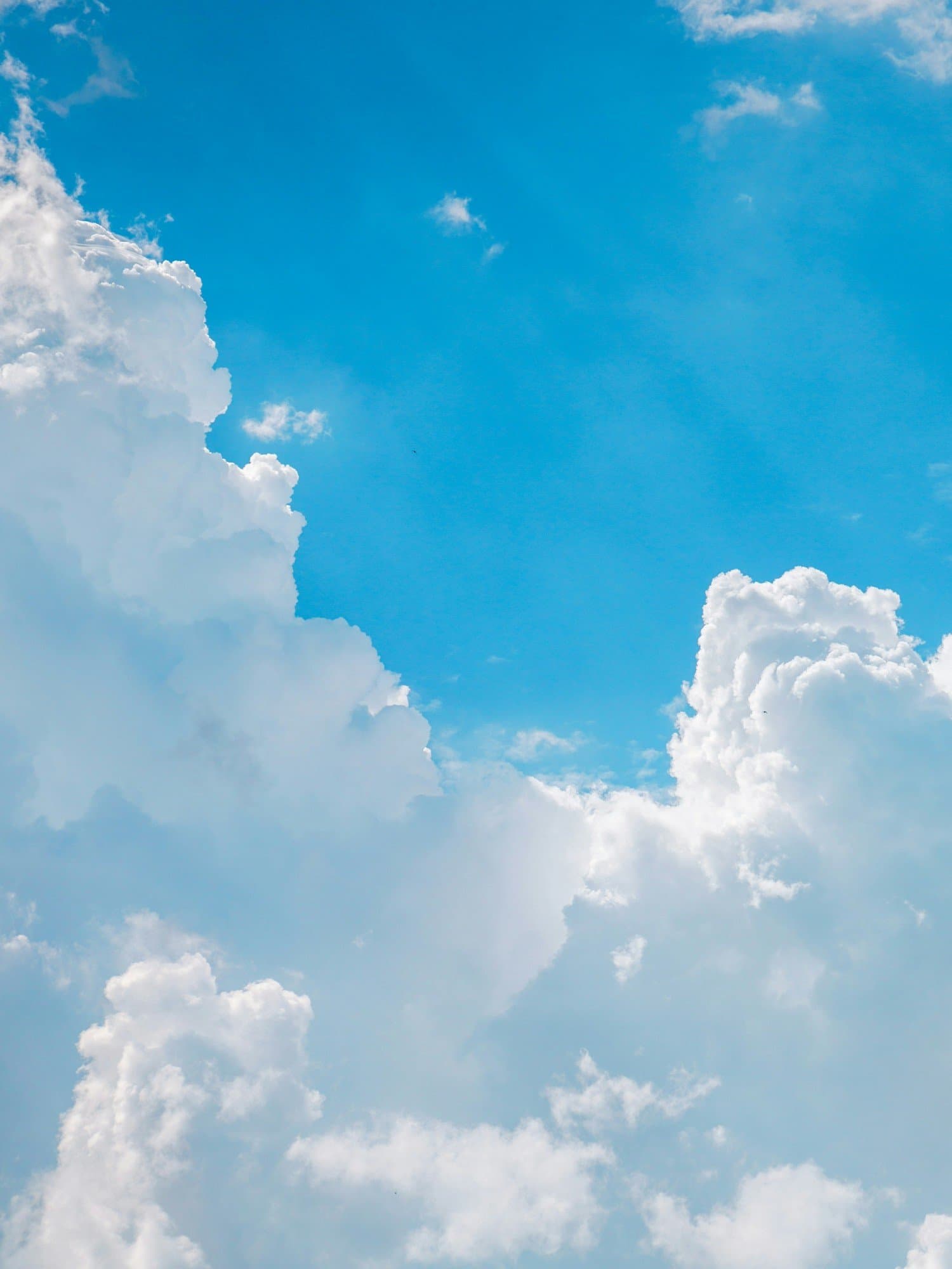 A calm blue sky with soft clouds
