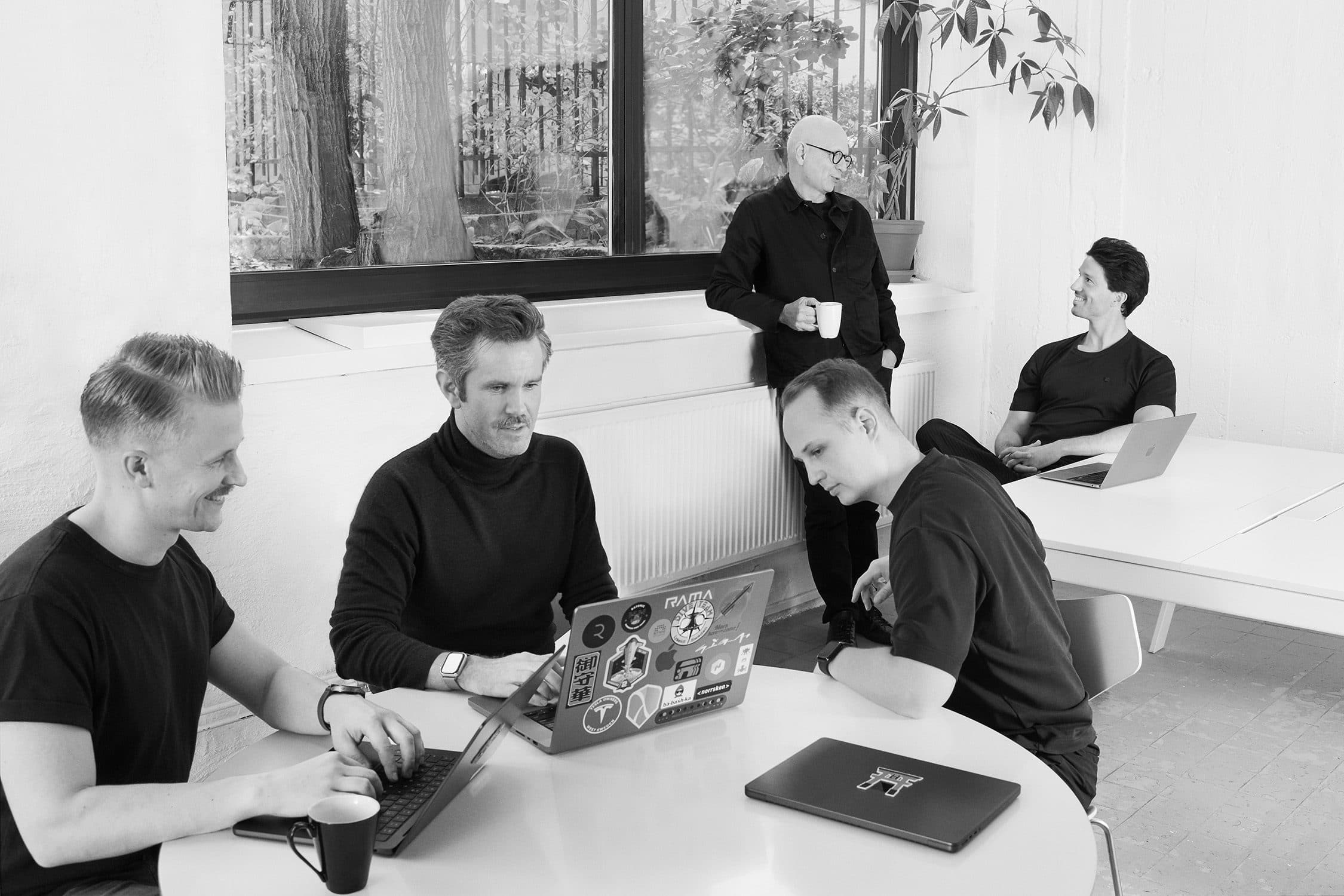 The Multiply team at work in the office, in black and white
